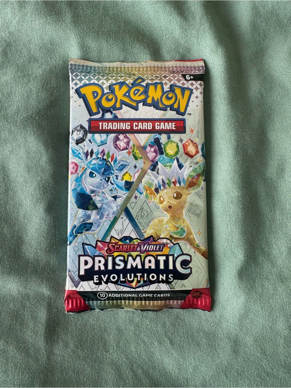 Pokemon Prismatic Evolutions Booster Pack - Blue, Yellow, Red, Green